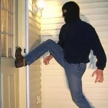 burglar kicking in a residential door